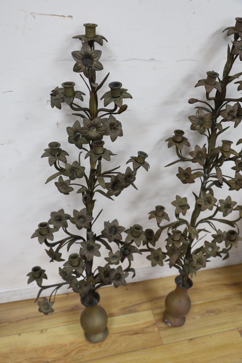 A pair of tall brass candelabra